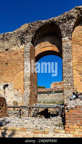 Taormina, Sicily, Italy - February 15, 2023: Greek and Roman period Teatro antico Ancient Theatre with stage and arches colonnade ruins Stock Photo