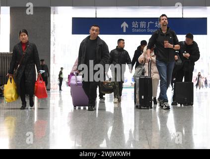 Beijing, China. 17th Feb, 2024. Passengers walk into Shapingba Railway Station in southwest China's Chongqing, Feb. 17, 2024. China witnessed an increase of passenger trips on the last day of the eight-day Spring Festival holiday. Credit: Wang Quanchao/Xinhua/Alamy Live News Stock Photo