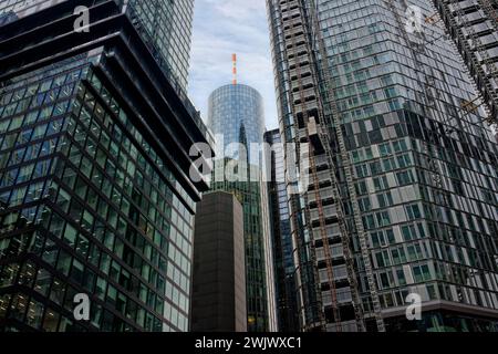 Construction site at the top of a skyscraper with reflection in the windows of the neighboring skyscraper. Stock Photo