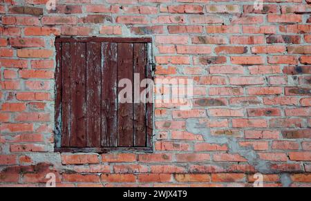 The texture of an old brick wall with natural defects. Scratches, cracks, crevices, chips, dust, roughness, abrasion. Template for design and backgrou Stock Photo