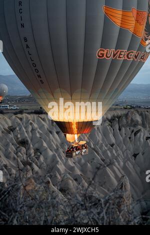 Göreme's Dawn: A Symphony of Balloons at Cappadocia's Sunrise Stock Photo