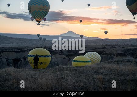 Göreme's Dawn: A Symphony of Balloons at Cappadocia's Sunrise Stock Photo