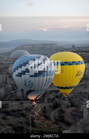 Göreme's Dawn: A Symphony of Balloons at Cappadocia's Sunrise Stock Photo