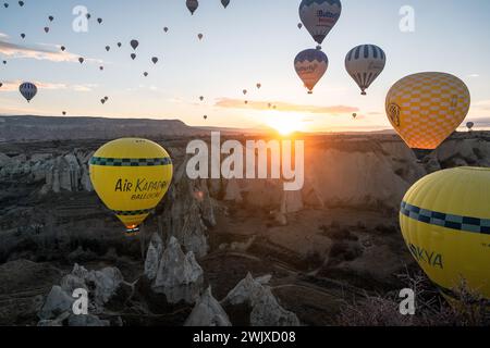 Göreme's Dawn: A Symphony of Balloons at Cappadocia's Sunrise Stock Photo