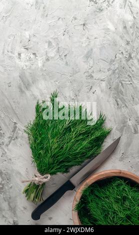 A bunch of fresh dill on the background of a wooden table. Fresh organic dill on a wooden background.Seasoning. Spice for different dishes. Dill close Stock Photo