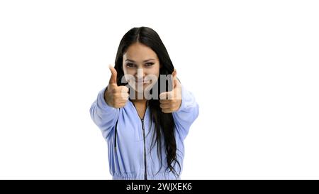 A woman, close-up, on a white background, shows her thumbs up Stock Photo