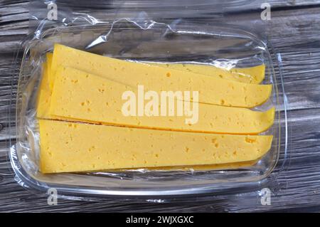 Slices of Egyptian Rumi cheese, also called gebna romiya or gebna turkiya, Roumi, Romi also Romy, middle Eastern parmesan hard cheese, has a pungent s Stock Photo