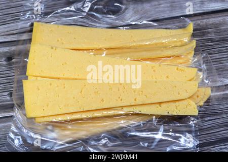 Slices of Egyptian Rumi cheese, also called gebna romiya or gebna turkiya, Roumi, Romi also Romy, middle Eastern parmesan hard cheese, has a pungent s Stock Photo