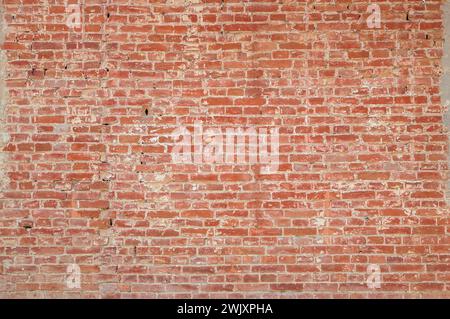Brick wall background. Urban rustic texture. Antique house exterior wall. Vintage abandoned building architecture. Red brick construction. Red and whi Stock Photo