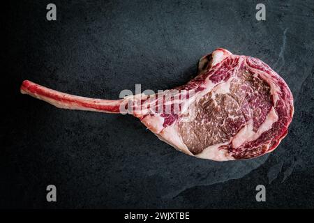 Wagyu tomahawk steak on a slate background Stock Photo