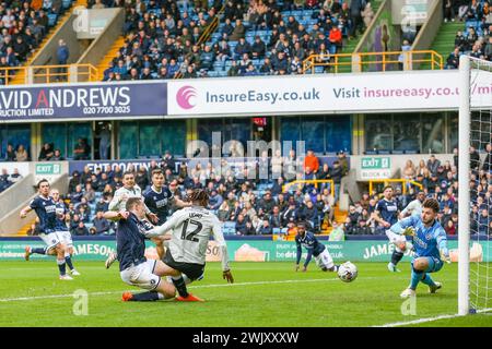 London, UK. 17th Feb, 2024. Sheffield Wednesday forward Ike Ugbo (12) scores a GOAL 0-1 past Millwall goalkeeper Matija Šarkic (20) during the Millwall FC v Sheffield Wednesday FC sky bet EFL Championship match at The Den, London, England, United Kingdom on 17 February 2024 Credit: Every Second Media/Alamy Live News Stock Photo