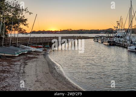 Sun setting behind marina on Ward Cove off of Rocky Bayou in Niceville, Florida Stock Photo