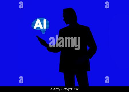 Silhouette of an elegant businessman using AI in a modern smartphone on social media, standing on a blue glowing background, a futuristic AI concept Stock Photo