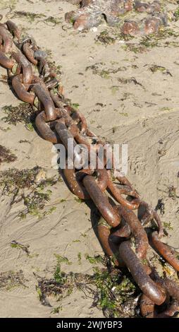 Old anchor chains on the seashore Stock Photo