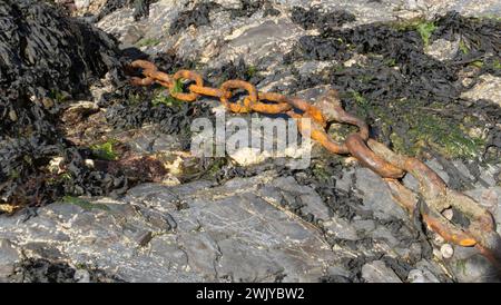 Old rusty chains on the seashore Stock Photo