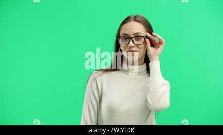 Woman, close-up, on a green background, wearing glasses Stock Photo