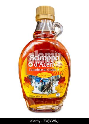 Italy - February 17, 2024: Canadian maple syrup in small glass bottle for sale in Italy, isolated on white with clipping path Stock Photo