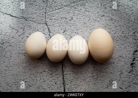 Four white eggs on an empty background. Easter concept Stock Photo