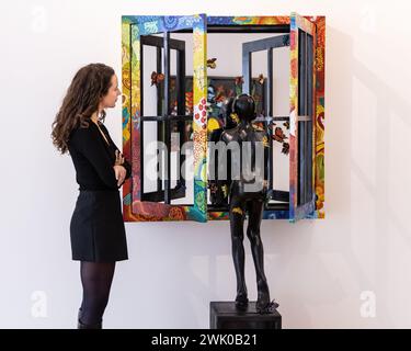 London, UK. 17th Feb, 2024. Art consultant Marina poses with 'The Other Side', 2022 in the new Peju Alatise exhibition 'We Came with the Last Rain'. Rele Gallery in Mayfair launches with its inaugural exhibition, running Mar 22nd - Apr 23rd 2024, with a solo show by Glasgow and Lagos based Nigerian artist Peju Alatise, a leading voice in contemporary African art. Many of the vibrant, intricate works feature African themes and patterns. Rele launch their London gallery having established practices in Lagos and L.A. Credit: Imageplotter/Alamy Live News Stock Photo