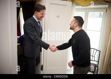Munich, Germany. 17th Feb, 2024. Ukrainian President Volodymyr Zelenskyy, center, shakes hands with Dutch Prime Minister Mark Rutte, left, before a bilateral meeting on the sidelines of the 60th Munich Security Conference at the Hotel Bayerischer Hof, February 17, 2024 in Munich, Germany. Credit: Pool Photo/Ukrainian Presidential Press Office/Alamy Live News Stock Photo