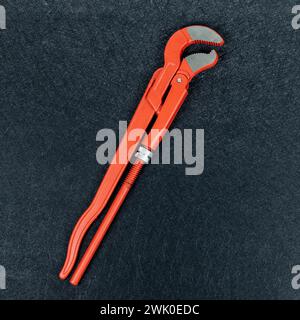 Pipe wrench on black background. Pipe wrench on black background. Nice copy space on detailed black background. Stock Photo