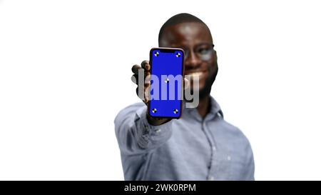 A man, close-up, on a white background, shows a phone Stock Photo