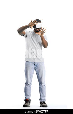 Man, full-length, on a white background, wearing VR glasses Stock Photo