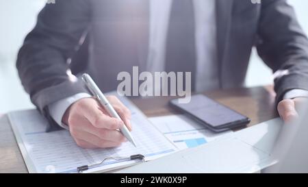 Checking reports, using the phone, working in the office Stock Photo