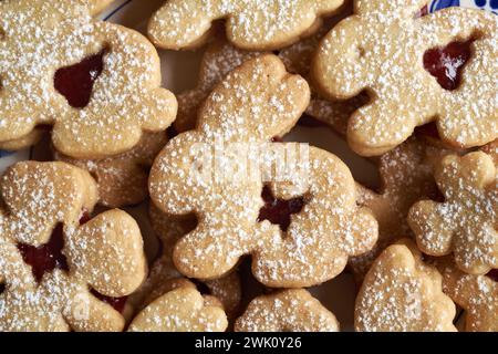 Bunny shaped homemade Linzer cookies filled with strawberry marmalade and dusted with sugar Stock Photo