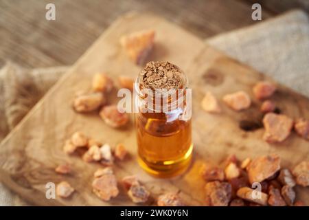 A transparent bottle of aromatherapy essential oil with styrax benzoin resin Stock Photo