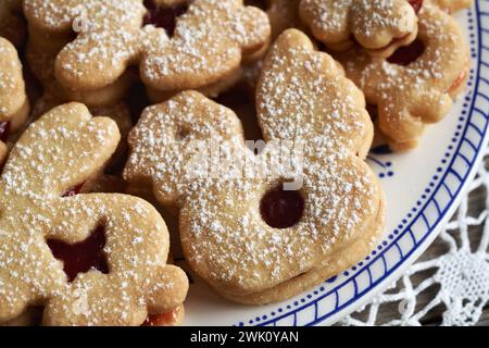 Chicken and bunny shaped Linzer Easter cookies filled with strawberry marmalade and dusted with sugar Stock Photo