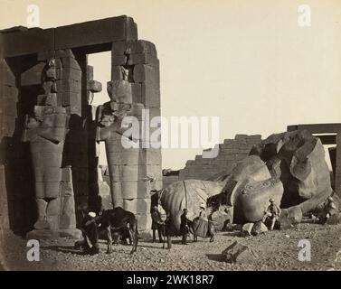 Fallen Statue at the Ramesseum, Thebes, Egypt.  Photograph by Francis Frith, 1857.  Albumen print from wet collodion negative. Conveys the monumentality of the ancient Egyptian sculpture by including members of his expedition in the picture of the statues. Stock Photo