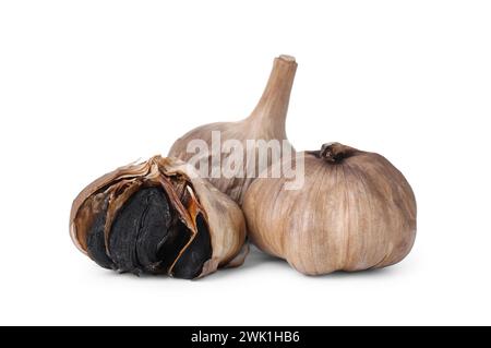 Bulbs of fermented black garlic isolated on white Stock Photo