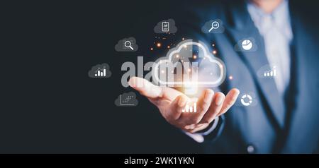 Businessman showing virtual glowing cloud computing to download and loading data information and upload on system network application. Technology data Stock Photo