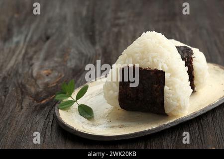 Onigiri Japanese Rice Ball with Nori Laver on Wooden Table Stock Photo