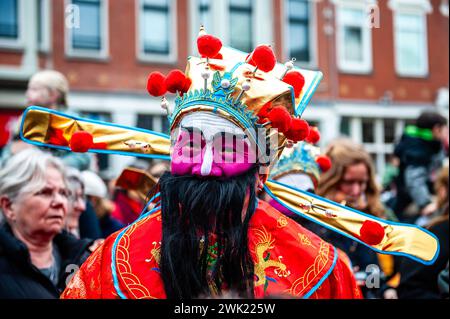 A man is seen wearing traditional Chinese clothes. Lion dancers and dragon dancers parade through the streets of Rotterdam to bless the new year entrepreneurs. The lion dance ceremony ensures that evil spirits are chased away and brings prosperity and happiness for the new year. Chinese communities around the world welcomed the Year of the Dragon on Tuesday, ushering in the Lunar New Year with prayers, family feasts, and shopping sprees. It is an annual 15-day festival that begins with the new moon between Jan. 21 and Feb. 20 in Western calendars. Stock Photo
