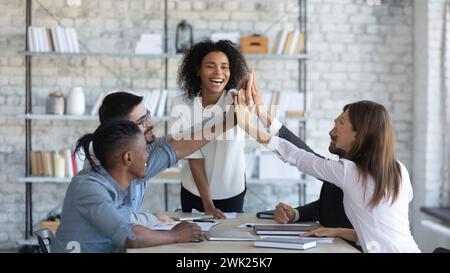 Young female business coach inspiring office workers to collaborate Stock Photo