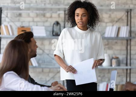 Young office worker making report in a meeting Stock Photo