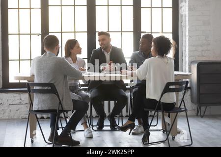 Young office workers having a meeting with director Stock Photo