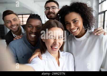 Group of happy, smiling office employees taking selfie at work Stock Photo