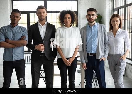 Group portrait of coworkers in formal wear in modern office Stock Photo