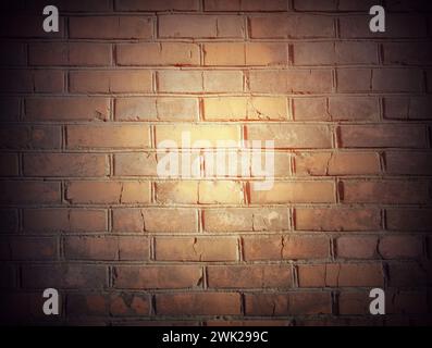 abstract old brick wall in the dark with spotlight warm light tone. brick wall in empty room. brick wall background for wallpaper Stock Photo