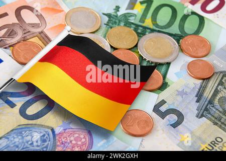 Euro banknotes and coins with German Flag Stock Photo