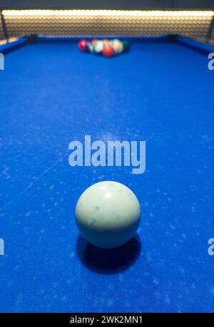 Full rack ready for the break shot. Eight-ball pool game at six pocket blue table. Stock Photo
