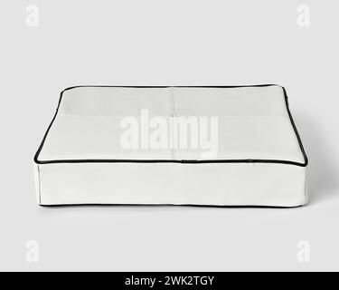 Minimalist floor cushion in white leather with black piping Stock Photo
