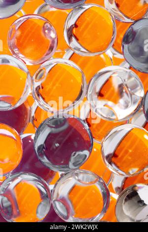 Orange, red and grey translucent crowded spheres composing a colorful background with a line reflection pattern Stock Photo