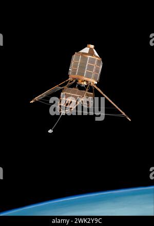 Model of Ariel scientific & research space satellite above Earth horizon. Experiments on electro magnetic radiation & high energy charged particles. Stock Photo