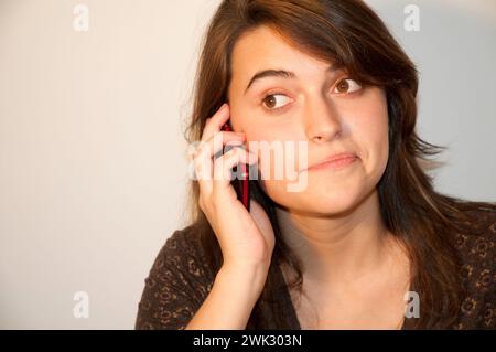 Young woman using mobile phone. Stock Photo