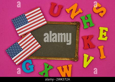 usa flag card with frame photo and alphabets on pink background. Concept of English language courses Stock Photo