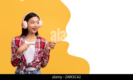 asian lady with headphones pointing aside at text bubble, collage Stock Photo